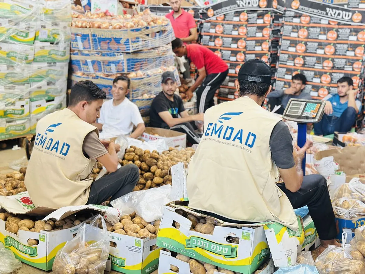 EMDAD team sourcing and weighing fresh produce at market